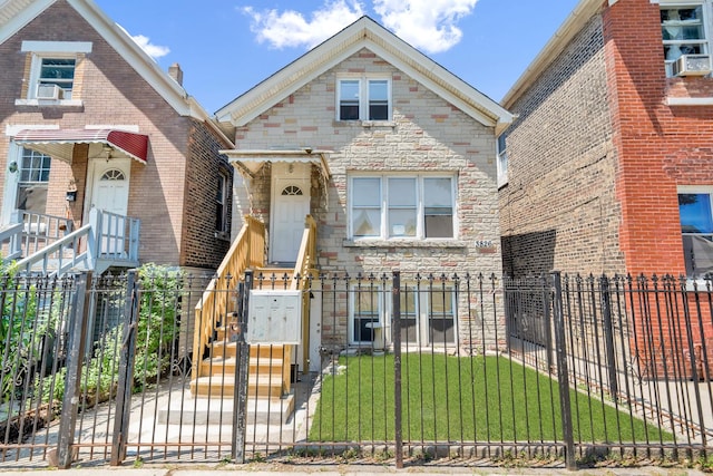 3826 S Honore St, Chicago, IL 60609 - view of front facade with a fenced front yard, stone siding, a gate, and cooling unit