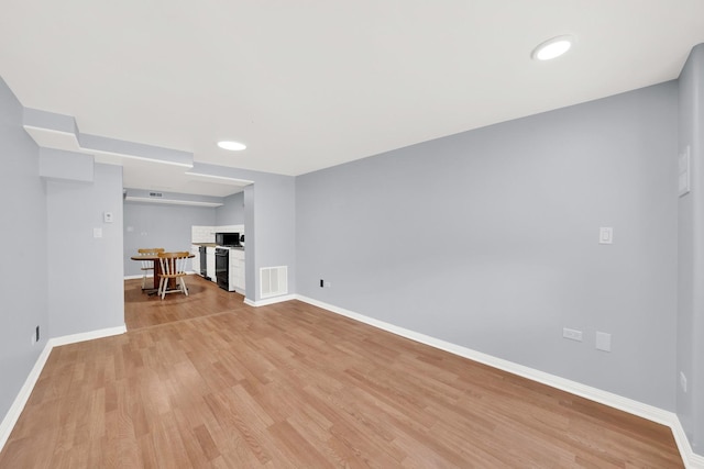3826 S Honore St, Chicago, IL 60609 - unfurnished living room with light wood-style flooring and recessed lighting
