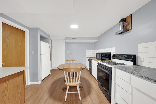 3826 S Honore St, Chicago, IL 60609 - kitchen with black appliances, backsplash, white cabinets, and light wood-style flooring