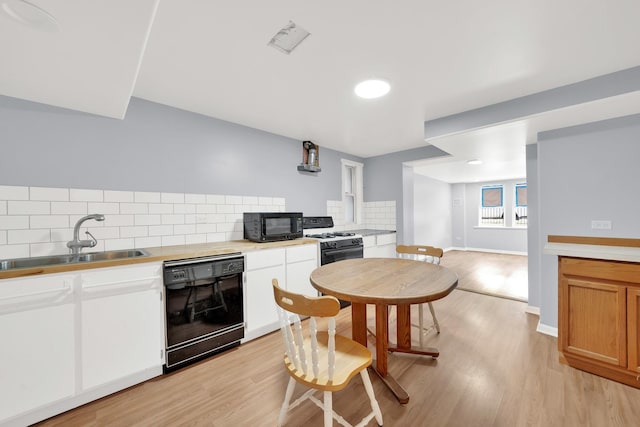 3826 S Honore St, Chicago, IL 60609 - kitchen with black appliances, light wood-style floors, backsplash, and light countertops