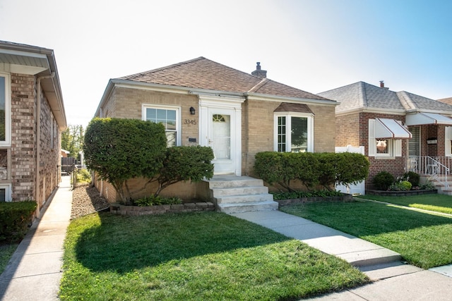 3345 N Page Ave, Chicago, IL 60634 - bungalow-style home featuring brick siding, a front yard, and roof with shingles