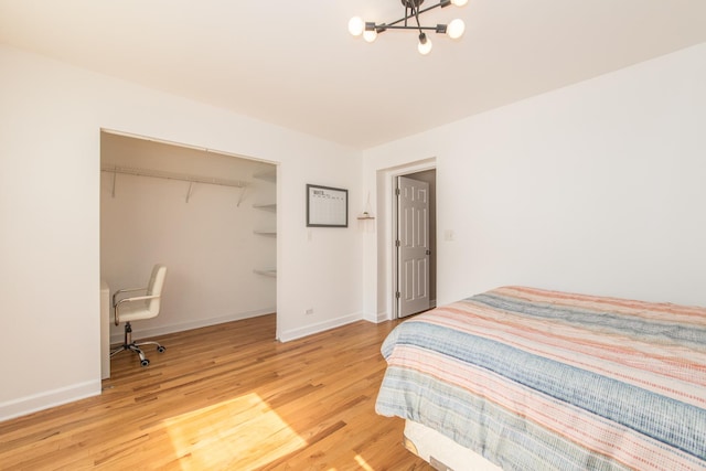 3345 N Page Ave, Chicago, IL 60634 - bedroom featuring light wood-style floors, a chandelier, and a closet