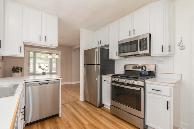 3345 N Page Ave, Chicago, IL 60634 - kitchen with appliances with stainless steel finishes, light countertops, tasteful backsplash, and white cabinetry