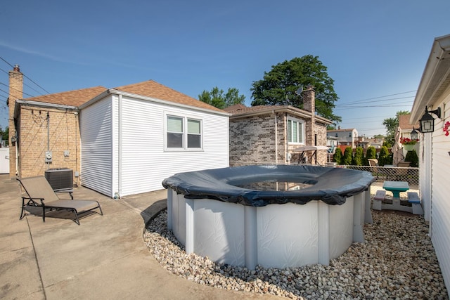 3345 N Page Ave, Chicago, IL 60634 - back of house with a covered pool, a chimney, and roof with shingles