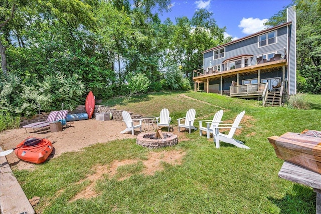 6 Barbados Ct N, Putnam, IL 61560 - view of grassy yard featuring an outdoor fire pit, a deck, and stairway