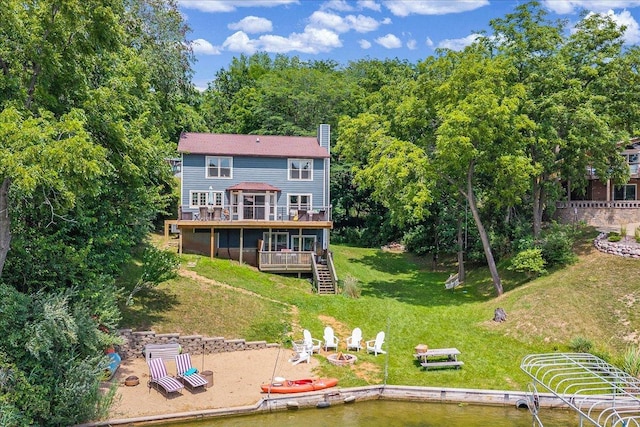 6 Barbados Ct N, Putnam, IL 61560 - back of property with a wooden deck, an outdoor fire pit, stairway, a chimney, and a lawn