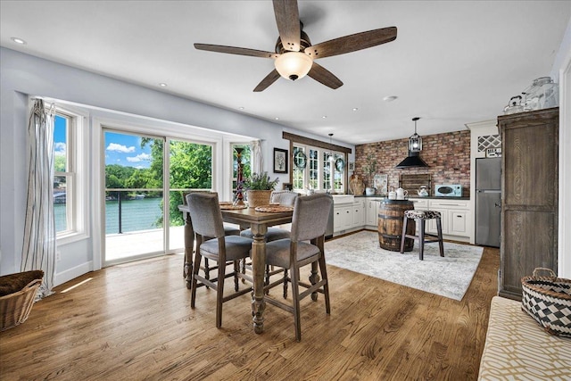 6 Barbados Ct N, Putnam, IL 61560 - dining space with ceiling fan, wood finished floors, recessed lighting, brick wall, and a water view
