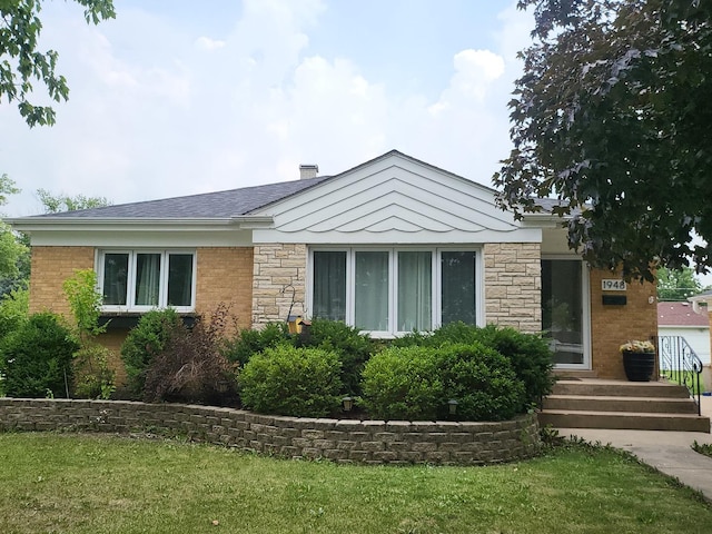 1948 Boeger Ave, Westchester, IL 60154 - view of front of home with stone siding, a front lawn, and a chimney