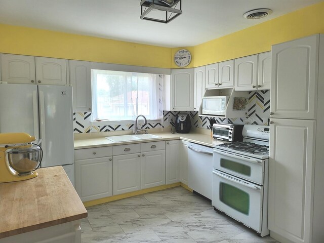1948 Boeger Ave, Westchester, IL 60154 - kitchen with white appliances, light marble finish floors, tasteful backsplash, light countertops, and white cabinets