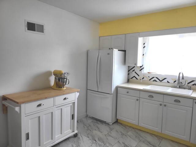 1948 Boeger Ave, Westchester, IL 60154 - kitchen with freestanding refrigerator, light marble finish flooring, wood counters, and white cabinets