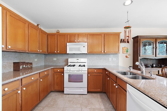 7672 Thistlewood Ln, Frankfort, IL 60423 - kitchen featuring white appliances, brown cabinetry, light tile patterned floors, and light stone counters