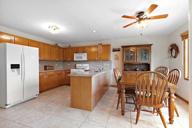 7672 Thistlewood Ln, Frankfort, IL 60423 - kitchen with white appliances, a peninsula, light countertops, ceiling fan, and tasteful backsplash