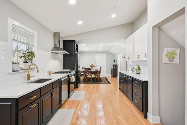 1610 S Greenwood Ave, Park Ridge, IL 60068 - kitchen with wall chimney range hood, light countertops, light wood-type flooring, lofted ceiling, and recessed lighting