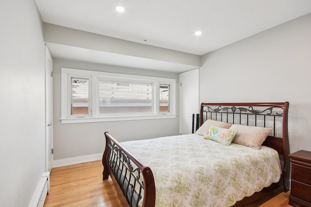 1610 S Greenwood Ave, Park Ridge, IL 60068 - bedroom featuring a baseboard heating unit, wood finished floors, and recessed lighting