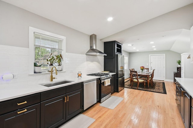1610 S Greenwood Ave, Park Ridge, IL 60068 - kitchen with wall chimney range hood, appliances with stainless steel finishes, lofted ceiling, light countertops, and tasteful backsplash