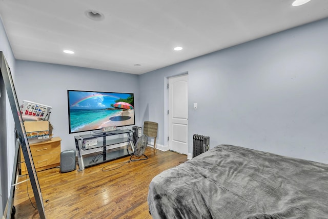 7627 S Prairie Ave, Chicago, IL 60619 - bedroom featuring recessed lighting, wood finished floors, and radiator