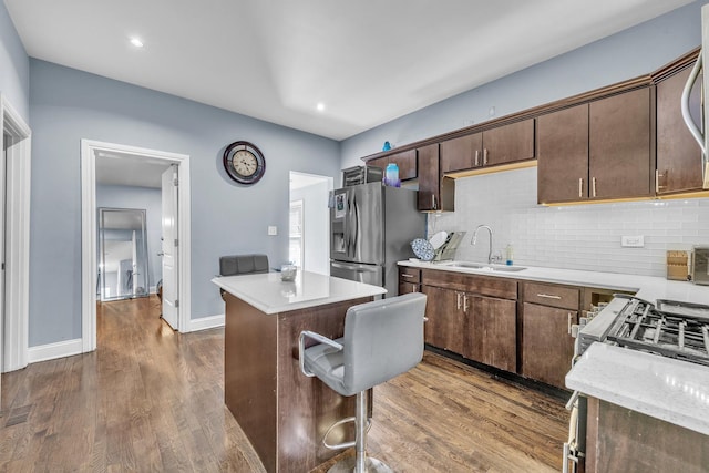 7627 S Prairie Ave, Chicago, IL 60619 - kitchen with stainless steel fridge, backsplash, dark wood-style floors, a center island, and dark brown cabinetry