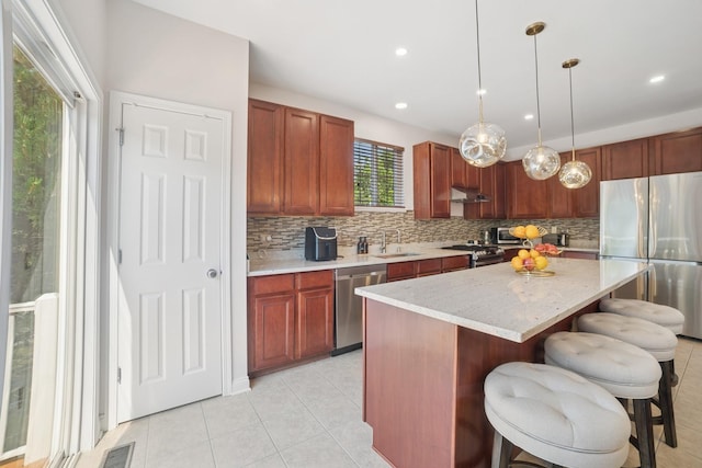 234 Cassidy Ln, Elgin, IL 60124 - kitchen featuring stainless steel appliances, under cabinet range hood, tasteful backsplash, light tile patterned floors, and recessed lighting