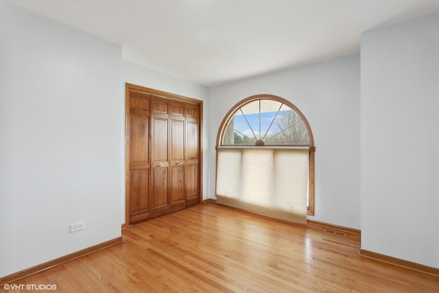 13714 S Janas Pkwy, Homer Glen, IL 60491 - unfurnished bedroom with light wood finished floors and a closet