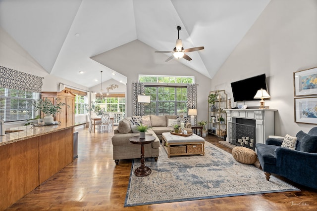 1728 Briarheath Dr, Aurora, IL 60505 - living area with wood finished floors, high vaulted ceiling, ceiling fan, a fireplace with raised hearth, and recessed lighting