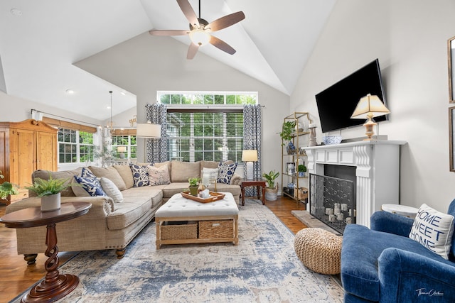 1728 Briarheath Dr, Aurora, IL 60505 - living area featuring high vaulted ceiling, a fireplace with raised hearth, a ceiling fan, plenty of natural light, and wood finished floors