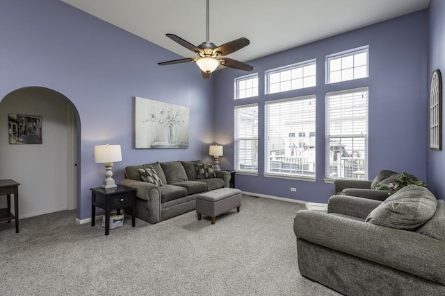1444 Baroque Ave, Volo, IL 60073 - carpeted living room with ceiling fan, a towering ceiling, and arched walkways