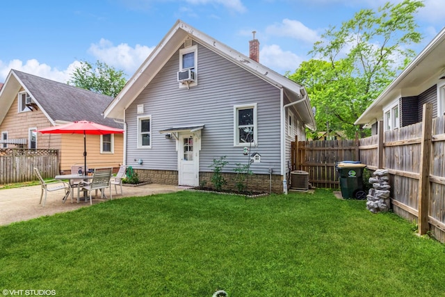 916 Pearl St, Aurora, IL 60505 - back of house with a chimney, a patio area, and cooling unit