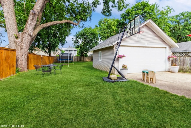 916 Pearl St, Aurora, IL 60505 - fenced backyard featuring a trampoline, an outdoor structure, and a garage