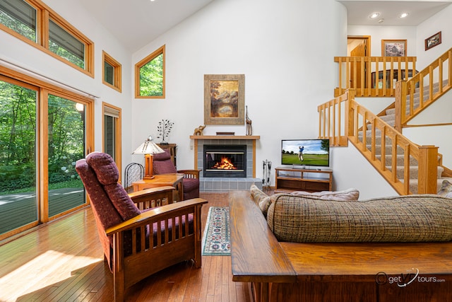 7 Vista Ridge Dr, Galena, IL 61036 - living room featuring high vaulted ceiling, a fireplace, hardwood / wood-style flooring, stairs, and recessed lighting
