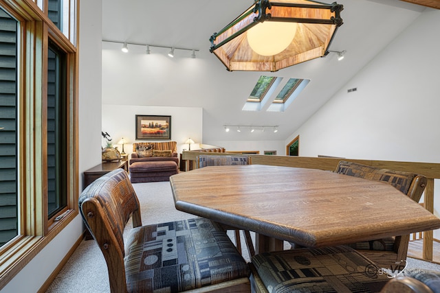 7 Vista Ridge Dr, Galena, IL 61036 - dining space featuring rail lighting, a skylight, carpet floors, and vaulted ceiling