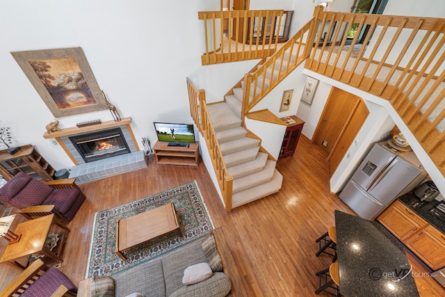 7 Vista Ridge Dr, Galena, IL 61036 - living area with wood finished floors, a tiled fireplace, and stairway