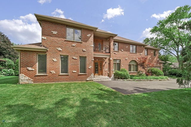 404 W Camp Mcdonald Rd, Prospect Heights, IL 60070 - view of front of house with brick siding, a balcony, a front yard, and roof with shingles