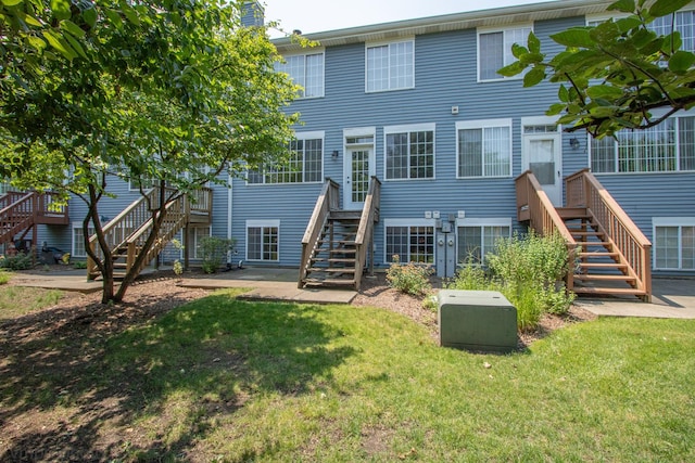 5584 Lavender Ct, Rolling Meadows, IL 60008 - rear view of house with stairs and a lawn