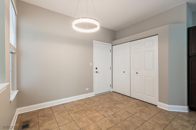 5584 Lavender Ct, Rolling Meadows, IL 60008 - unfurnished bedroom with light tile patterned floors and a closet