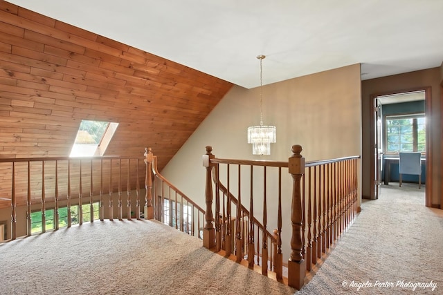 1815 Vineyard Ln, Spring Grove, IL 60081 - hallway with carpet floors, an upstairs landing, a chandelier, and a skylight