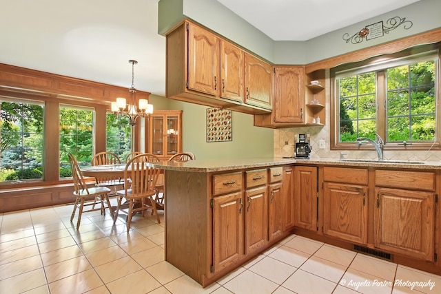 1815 Vineyard Ln, Spring Grove, IL 60081 - kitchen with plenty of natural light, backsplash, light stone countertops, and a chandelier