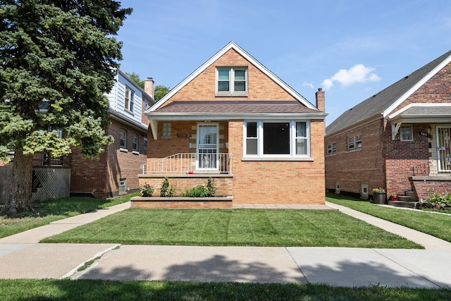 5339 S Kildare Ave, Chicago, IL 60632 - bungalow-style house with brick siding, a front yard, and a porch
