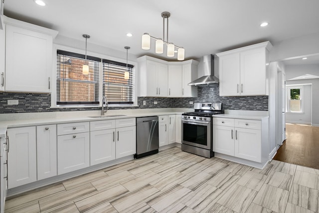 5339 S Kildare Ave, Chicago, IL 60632 - kitchen featuring stainless steel appliances, light countertops, white cabinetry, wall chimney range hood, and recessed lighting