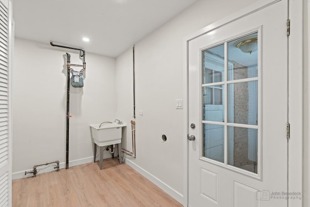 7025 W Berwyn Ave, Chicago, IL 60656 - laundry area with light wood-style flooring and recessed lighting