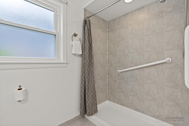 7025 W Berwyn Ave, Chicago, IL 60656 - full bathroom featuring a tile shower and tile patterned floors