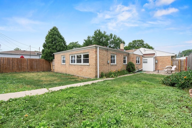 7025 W Berwyn Ave, Chicago, IL 60656 - back of property with a fenced backyard, a patio, brick siding, and a chimney