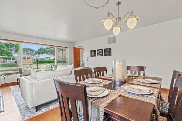 7025 W Berwyn Ave, Chicago, IL 60656 - dining area with wood finished floors and a chandelier