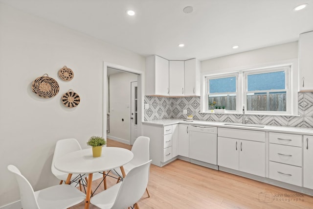7025 W Berwyn Ave, Chicago, IL 60656 - kitchen featuring dishwasher, backsplash, light countertops, recessed lighting, and light wood-style floors