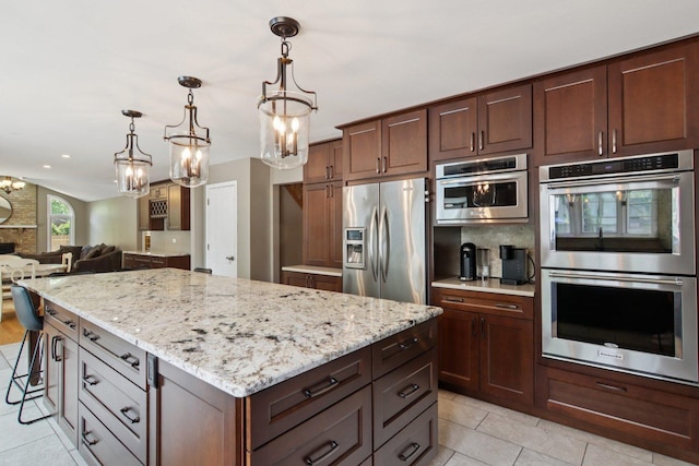 10215 S 87th Ct, Palos Hills, IL 60465 - kitchen featuring appliances with stainless steel finishes, light tile patterned floors, light stone countertops, open floor plan, and recessed lighting