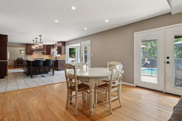 10215 S 87th Ct, Palos Hills, IL 60465 - dining room featuring french doors, light wood-type flooring, recessed lighting, and a chandelier