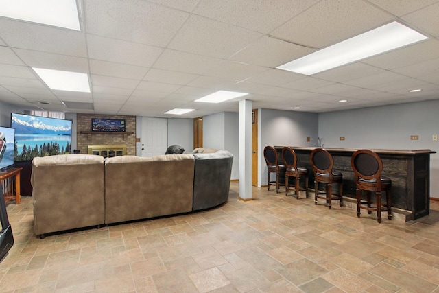 10215 S 87th Ct, Palos Hills, IL 60465 - living area featuring a dry bar, stone tile floors, a drop ceiling, and a fireplace