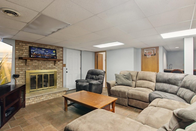 10215 S 87th Ct, Palos Hills, IL 60465 - living room featuring a fireplace, stone finish floors, and a drop ceiling
