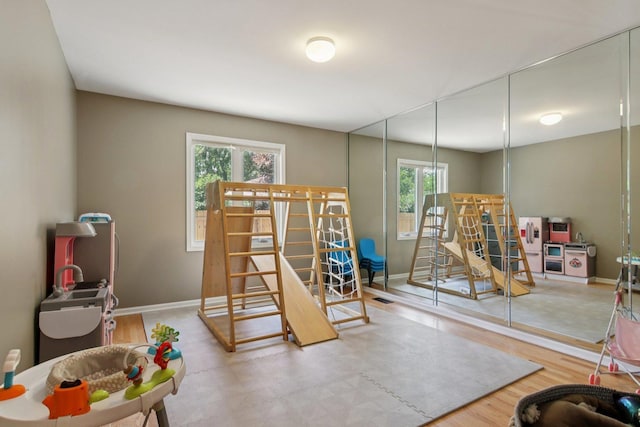 10215 S 87th Ct, Palos Hills, IL 60465 - game room featuring healthy amount of natural light and wood finished floors