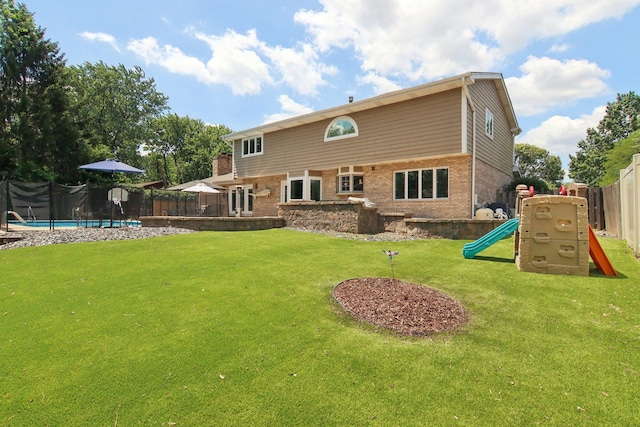 10215 S 87th Ct, Palos Hills, IL 60465 - rear view of house featuring a playground, brick siding, a fenced backyard, and a trampoline