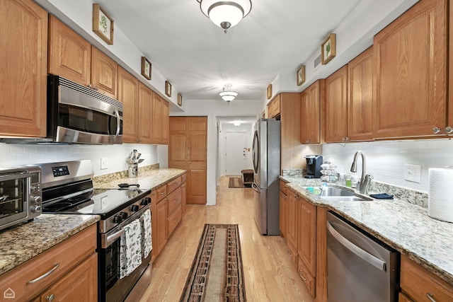 740 Saint Andrews Ln Unit 5, Crystal Lake, IL 60014 - kitchen featuring stainless steel appliances, light wood-type flooring, light stone countertops, and backsplash
